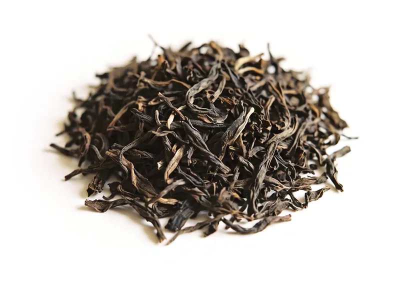 A small heap of dry loose-leaf black tea